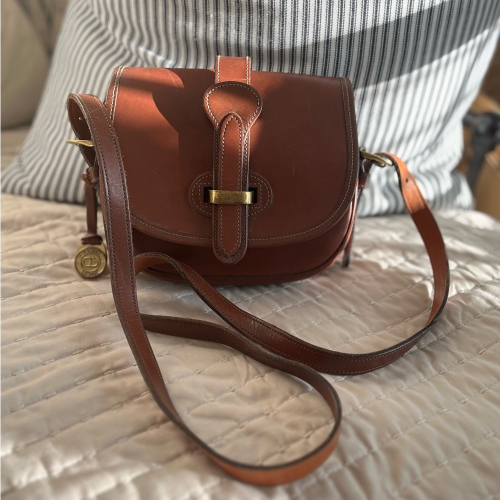 Dooney & Bourke Brown Crossbody Bag with Flap Closure and Adjustable Strap